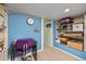 Basement features a desk, shelving, and blue painted walls creating a cozy and functional space at 2514 N Humboldt St, Denver, CO 80205