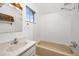 Bathroom features a tub, sink, and window at 2514 N Humboldt St, Denver, CO 80205