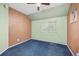 Neutral bedroom featuring paneled walls, blue carpet, and a ceiling fan at 2514 N Humboldt St, Denver, CO 80205