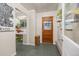 Inviting entryway with tile flooring, coat rack, and view to a bright utility room at 2514 N Humboldt St, Denver, CO 80205