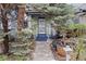 Inviting front porch framed by mature trees, landscaping and walkway at 2514 N Humboldt St, Denver, CO 80205