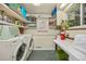 Functional laundry room with washer, dryer, storage shelves, and utility sink at 2514 N Humboldt St, Denver, CO 80205