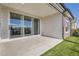 Covered patio with sliding glass doors overlooking the artificial turf is perfect for relaxing outdoors at 4955 N Picadilly Ct, Aurora, CO 80019