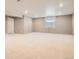 Spacious unfinished basement with painted walls and plush carpeting offers endless possibilities at 4955 N Picadilly Ct, Aurora, CO 80019