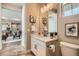 Bright bathroom features a white vanity, framed art, and access to an open-concept living space at 4955 N Picadilly Ct, Aurora, CO 80019