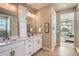 Bright bathroom with double vanity, white cabinets, and natural light; perfect for morning routines at 4955 N Picadilly Ct, Aurora, CO 80019