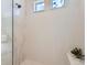 Sleek shower with white tiling, glass partition, and contemporary fixtures provides a spa-like experience at 4955 N Picadilly Ct, Aurora, CO 80019