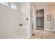 Modern bathroom with a glass-enclosed shower, tiled walls, and a view into the walk-in closet at 4955 N Picadilly Ct, Aurora, CO 80019
