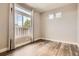 This bedroom is naturally lit with large windows and features elegant wood floors at 4955 N Picadilly Ct, Aurora, CO 80019