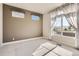 Bright empty room with neutral carpet and large windows, ready for your personal touch at 4955 N Picadilly Ct, Aurora, CO 80019