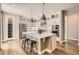 Modern kitchen with hardwood floors, a large island, stainless steel appliances, and sleek white cabinets at 4955 N Picadilly Ct, Aurora, CO 80019