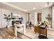 Open-concept living space with hardwood floors and stylish decor, plus entrance to bathroom at 4955 N Picadilly Ct, Aurora, CO 80019