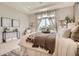 Serene bedroom featuring soft textures, natural light, and elegant furnishings for ultimate relaxation at 4955 N Picadilly Ct, Aurora, CO 80019