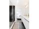 Modern bathroom featuring a glass-enclosed shower and sleek white vanity with integrated sink at 1168 S Reed Way, Lakewood, CO 80232