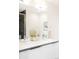 Bright bathroom with double sinks, gray countertop, and modern fixtures at 1168 S Reed Way, Lakewood, CO 80232