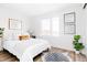 Bright bedroom with a large window, white bedding, and stylish decor, creating a serene atmosphere at 1168 S Reed Way, Lakewood, CO 80232