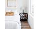 Cozy bedroom featuring a plush bed, artistic wall decor, and a chic nightstand with a modern lamp at 1168 S Reed Way, Lakewood, CO 80232