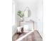 Inviting entryway with a wooden console table, round mirror, and stylish rug at 1168 S Reed Way, Lakewood, CO 80232