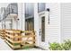 Contemporary townhouse showcasing white siding, dark window frames, and a wooden fence enclosing a small yard at 1168 S Reed Way, Lakewood, CO 80232