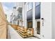 Contemporary townhouse row featuring wood fencing and modern white siding with black accents and entryways at 1168 S Reed Way, Lakewood, CO 80232