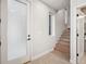 Bright entryway with a frosted glass door, wooden stairs, and stylish neutral flooring at 2326 Eliot St # 3, Denver, CO 80211