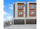 Contemporary townhouse featuring two-car garage, light gray siding, and wood-trimmed windows at 2326 Eliot St # 3, Denver, CO 80211