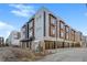 Contemporary townhome showcasing modern design, wood accents, and attached garages at 2326 Eliot St # 3, Denver, CO 80211