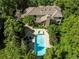 Stunning aerial view of the property featuring a pool, spa, patio, and lush landscaping at 5550 Preserve Dr, Greenwood Village, CO 80121