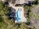 Aerial view of the pool, hot tub, and stone fireplace in a private backyard with mature landscaping at 5550 Preserve Dr, Greenwood Village, CO 80121