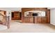 Finished basement with a bar, fireplace, and built-in shelving at 5550 Preserve Dr, Greenwood Village, CO 80121