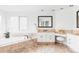Bright and elegant bathroom featuring a soaking tub, vanity with marble countertops, and decorative accents, offers a luxurious spa-like experience at 5550 Preserve Dr, Greenwood Village, CO 80121