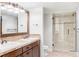 Bathroom with a double vanity and a tiled glass shower at 5550 Preserve Dr, Greenwood Village, CO 80121