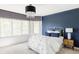 Charming bedroom featuring a statement wall, a white iron bed, and large windows, creating a tranquil and stylish retreat at 5550 Preserve Dr, Greenwood Village, CO 80121