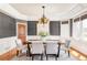 Elegant dining room featuring a stylish chandelier, large windows, and contemporary decor at 5550 Preserve Dr, Greenwood Village, CO 80121
