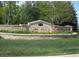 Stone monument sign for The Preserve community with colorful flowers and lush landscaping at 5550 Preserve Dr, Greenwood Village, CO 80121