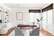 Stylish home office with built-in shelving, large window, and wood floors at 5550 Preserve Dr, Greenwood Village, CO 80121