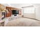 Cozy living room with a stone fireplace and a large flatscreen TV at 5550 Preserve Dr, Greenwood Village, CO 80121