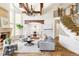 Open-concept living room with a grand staircase, fireplace, and an archway to the dining room at 5550 Preserve Dr, Greenwood Village, CO 80121
