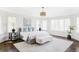 Bright primary bedroom with multiple windows, neutral decor, and a cozy bench, creating a serene and inviting retreat at 5550 Preserve Dr, Greenwood Village, CO 80121