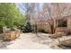 Outdoor kitchen and patio area, perfect for entertaining, surrounded by lush landscaping and a brick house at 5550 Preserve Dr, Greenwood Village, CO 80121