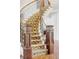Elegant curved staircase featuring patterned carpet and dark wood railings, adding a touch of sophistication to the home's interior at 5550 Preserve Dr, Greenwood Village, CO 80121