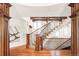 Grand foyer with a curved wood staircase and hardwood floors at 5550 Preserve Dr, Greenwood Village, CO 80121