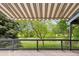 Back porch with a retractable awning, and a lovely view to the green yard at 14186 E Hampden Pl, Aurora, CO 80014