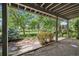 Covered outdoor patio area with stone floor and a view of the beautiful green lawn at 14186 E Hampden Pl, Aurora, CO 80014