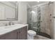 Bathroom boasts a marble vanity and a modern glass shower with unique tile accents at 14186 E Hampden Pl, Aurora, CO 80014