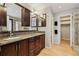 Bathroom featuring double vanity, granite countertop, and walk-in shower at 14186 E Hampden Pl, Aurora, CO 80014