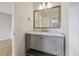 Bathroom with gray vanity with marble countertop, a large mirror, and modern fixtures at 14186 E Hampden Pl, Aurora, CO 80014