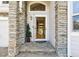 Welcoming front entrance with stone columns, an arched window, and a sidelight at 14186 E Hampden Pl, Aurora, CO 80014