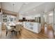 Kitchen with white cabinets, stainless appliances and adjacent dining table for easy entertaining at 14186 E Hampden Pl, Aurora, CO 80014