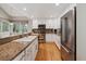 Updated kitchen featuring stainless appliances, granite counters, and bright natural light at 14186 E Hampden Pl, Aurora, CO 80014